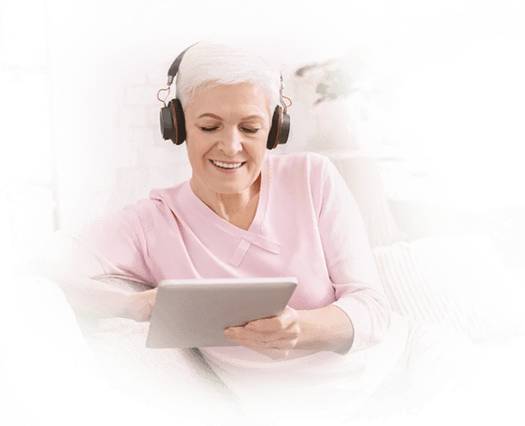 Senior woman enjoying Gamma Game brain training on tablet with headphones